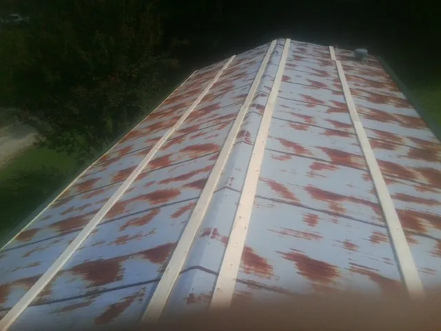 Rusted metal roof panels with new wood purlins before replacement — Storm Damage Roof Repair in Fresh Meadows by Roofing Brothers