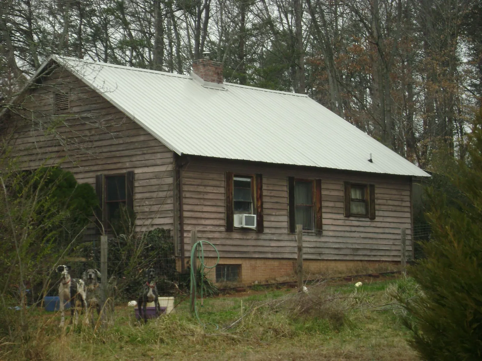 White metal roof on an old wood sided farmhouse, from a Metal Roof Installation job in Fresh Meadows